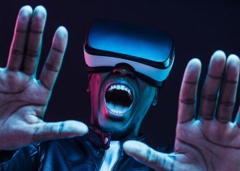 Headshot of excited young african man enjoying virtual reality with mouth wide open