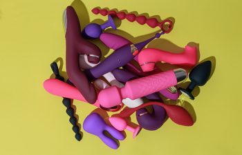 Different adult sex toys such as dildo, vibrator, buttplug on yellow background. High quality photo